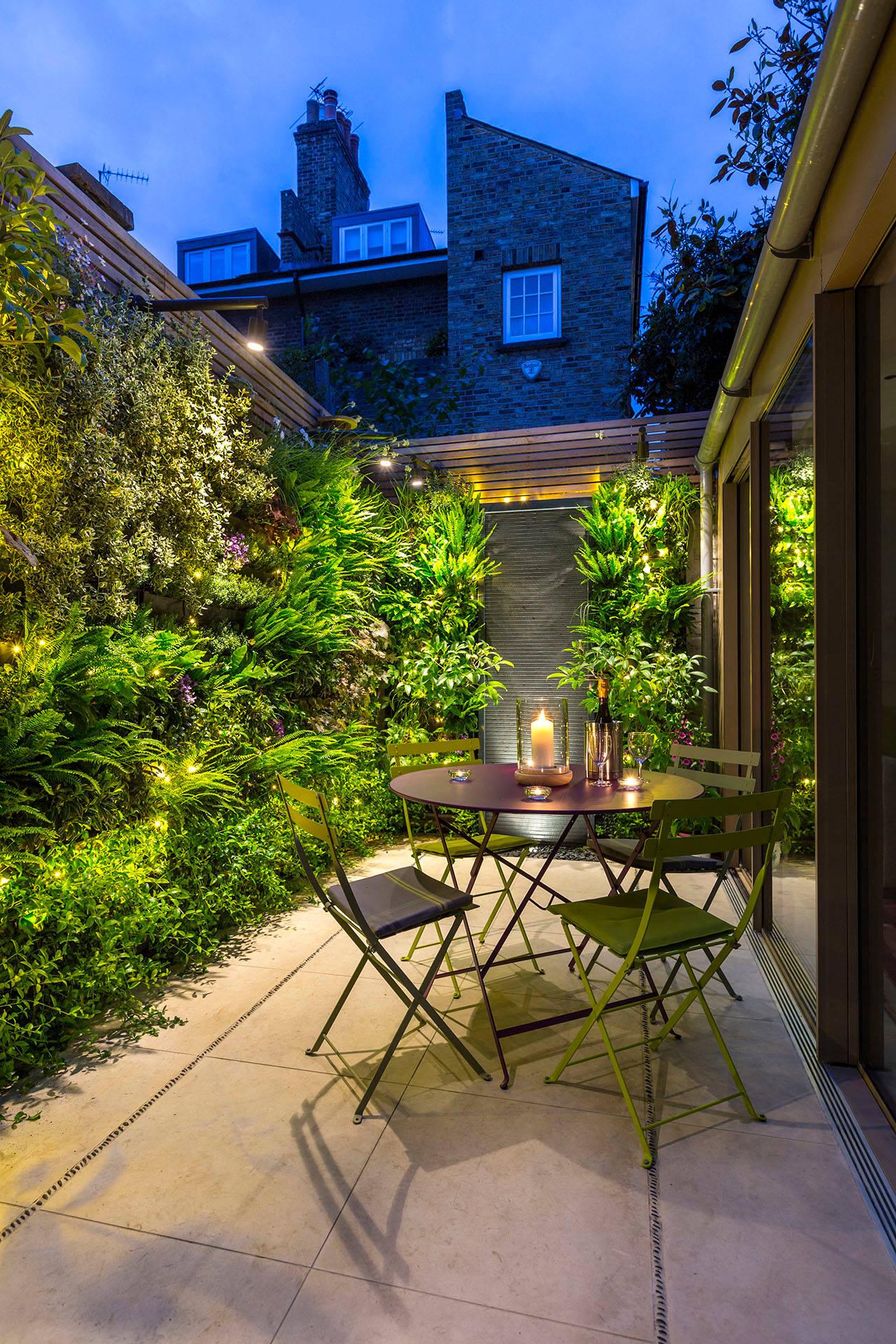 Lush ​vertical garden adds greenery to your patio design, enhancing outdoor aesthetics