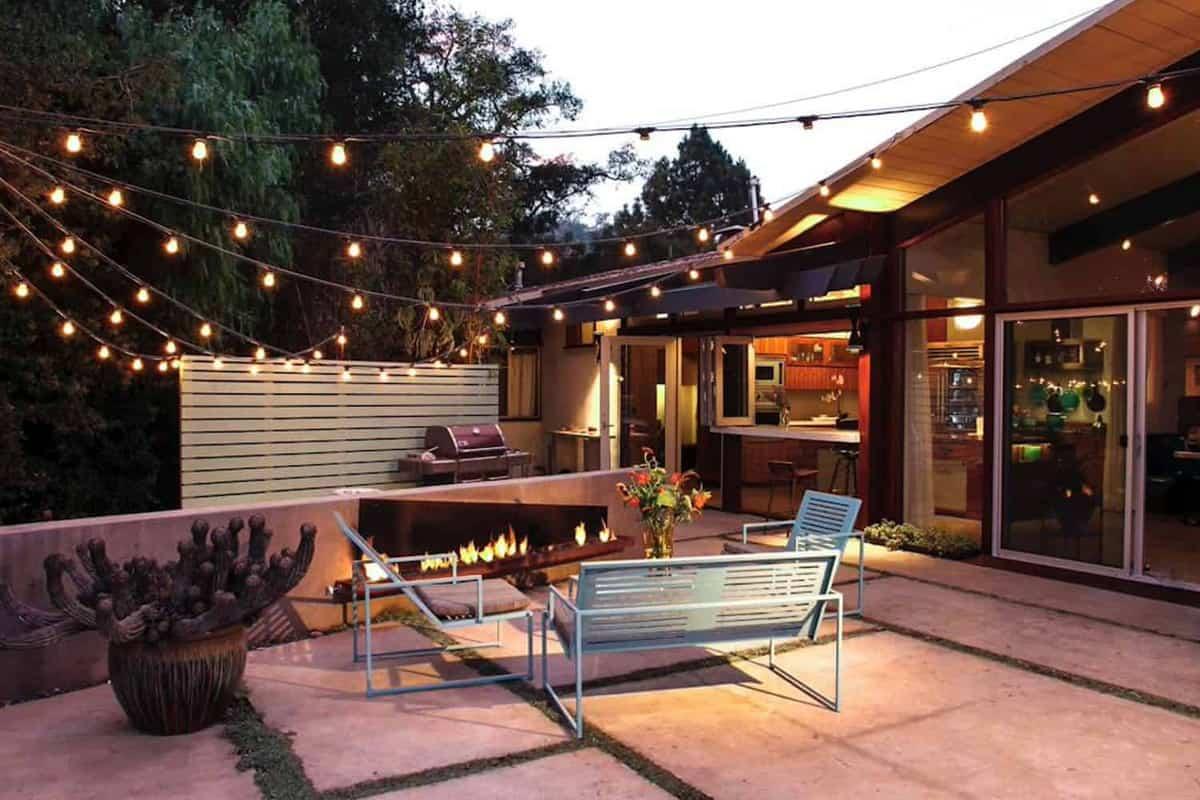 Use string lights to create a magical atmosphere in your modern backyard