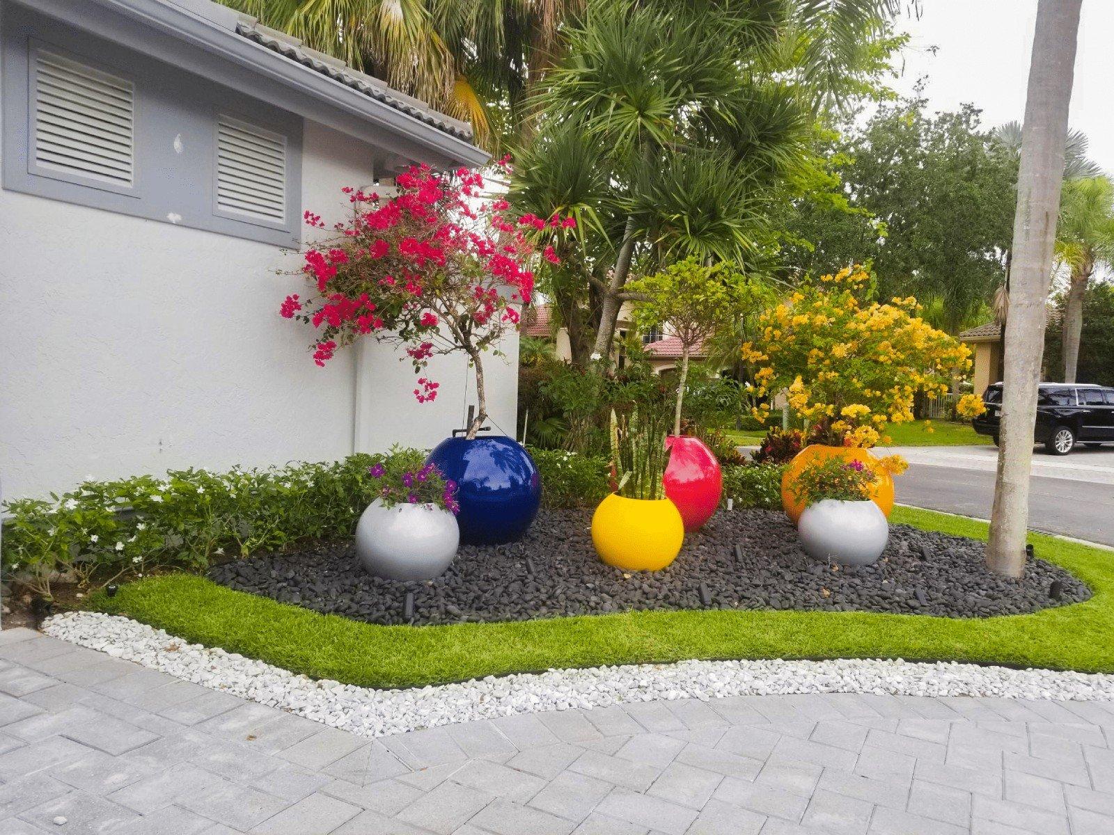 Add colorful planters to enhance the aesthetic of your backyard design