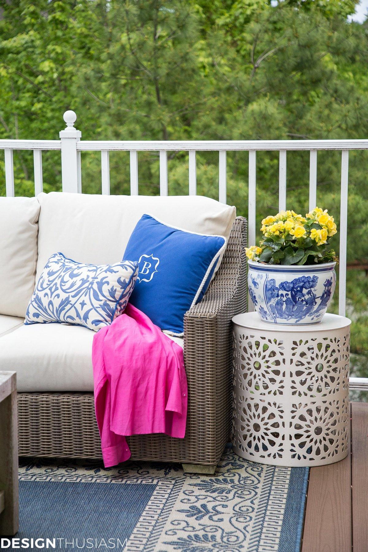 Add colorful pillows for an inviting vibe in small patio design