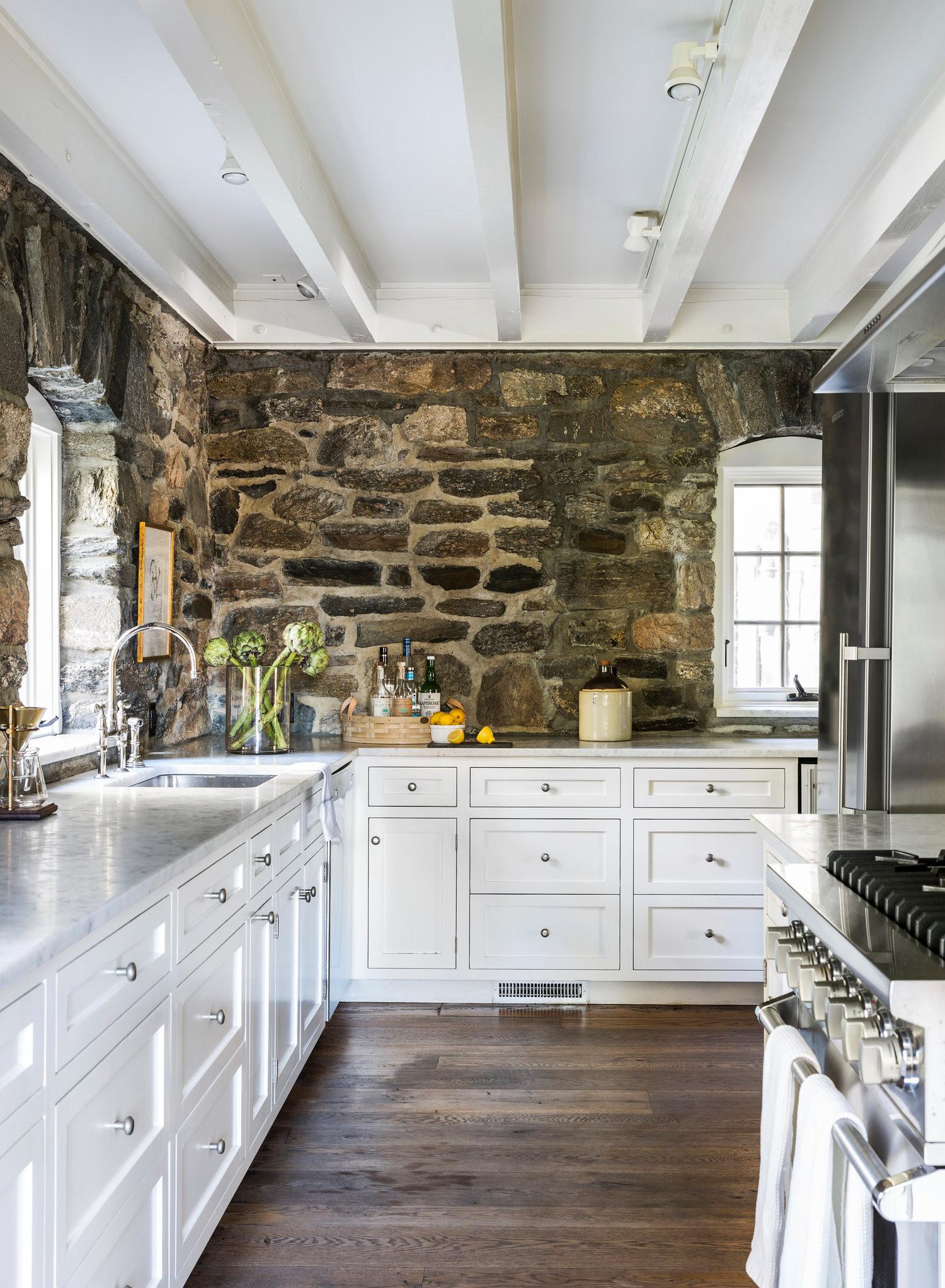 A brick or ​stone backsplash can make your country kitchen pop