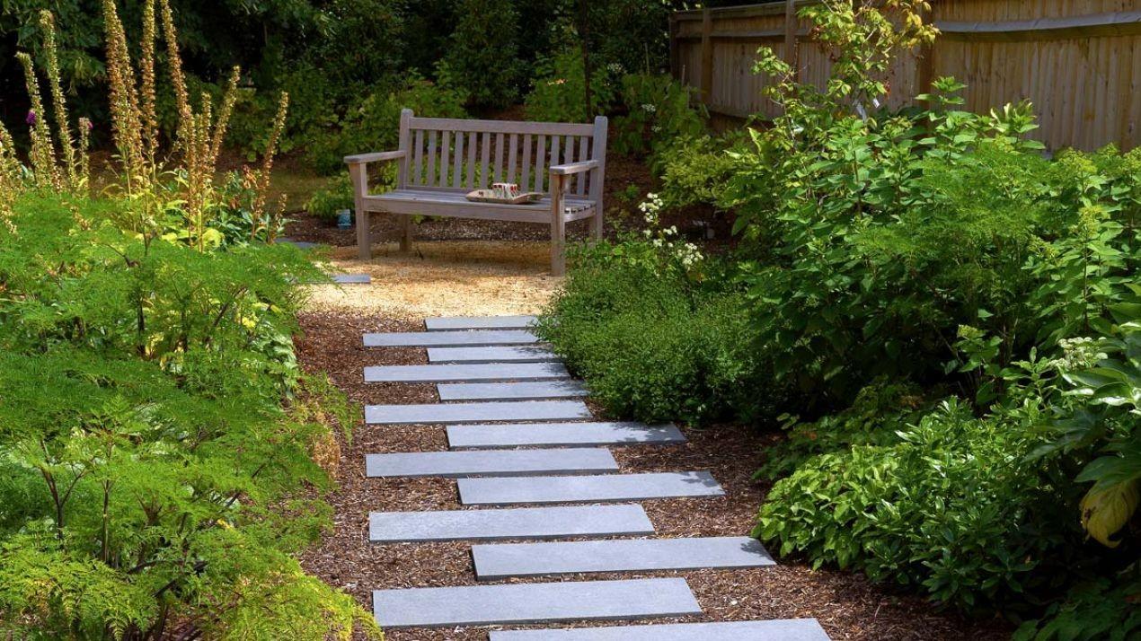 Utilize paving stones to create walkways in your modern backyard