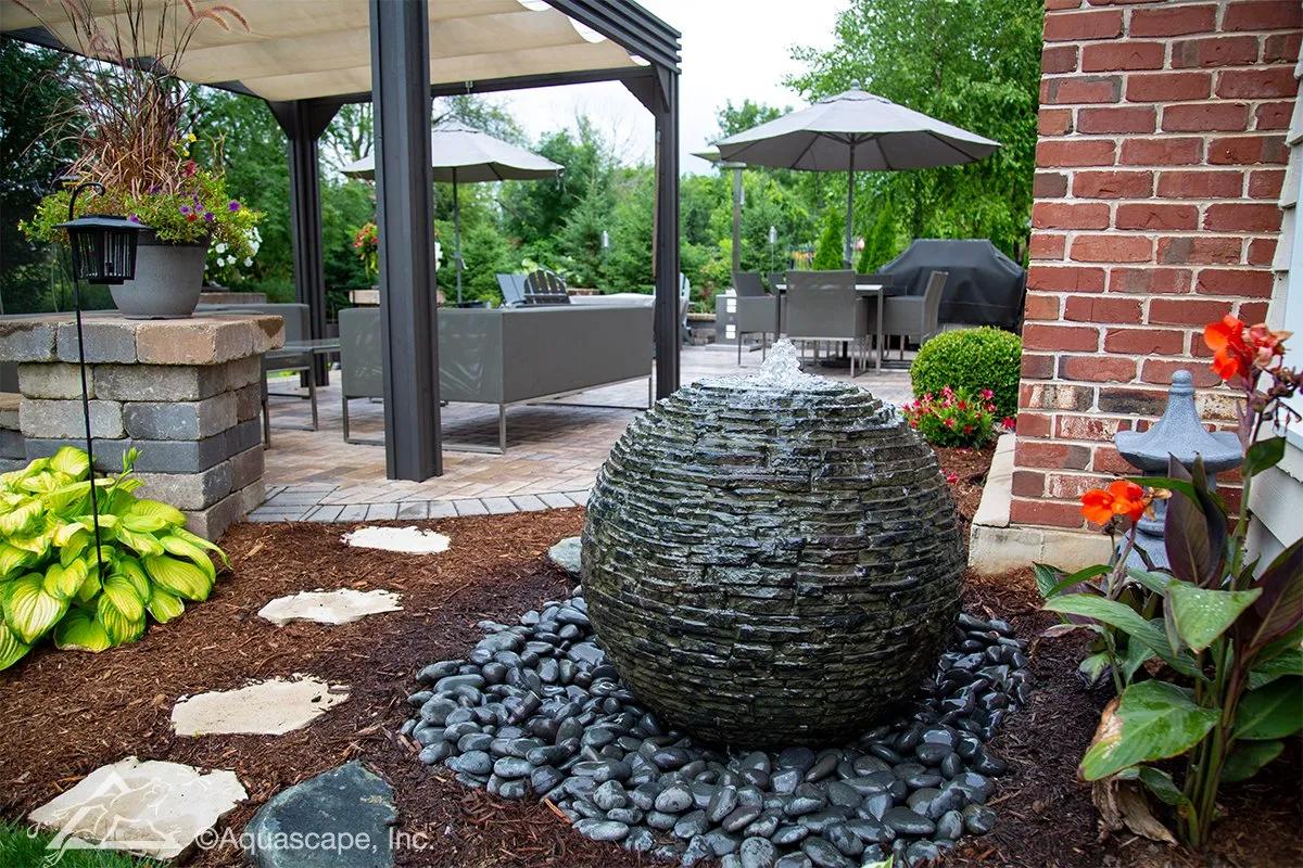 Incorporate a water fountain for a calming sound in your backyard design