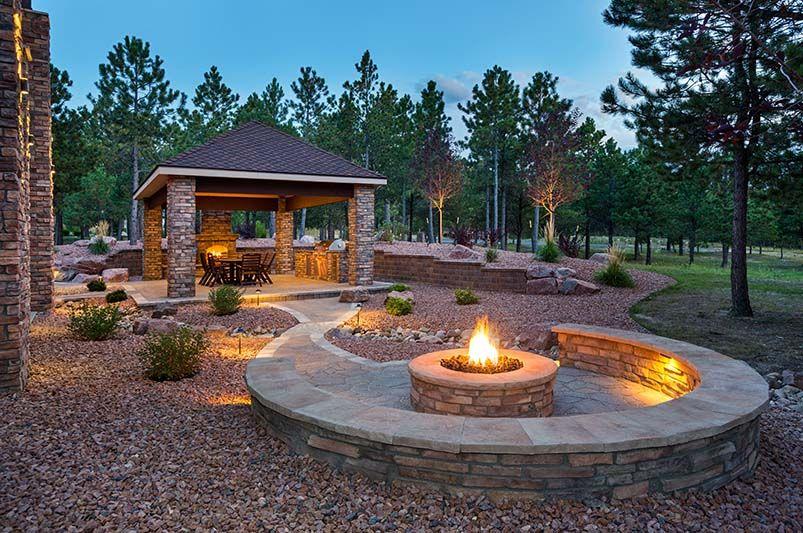 Incorporate a fire pit for warmth and gathering in your backyard design