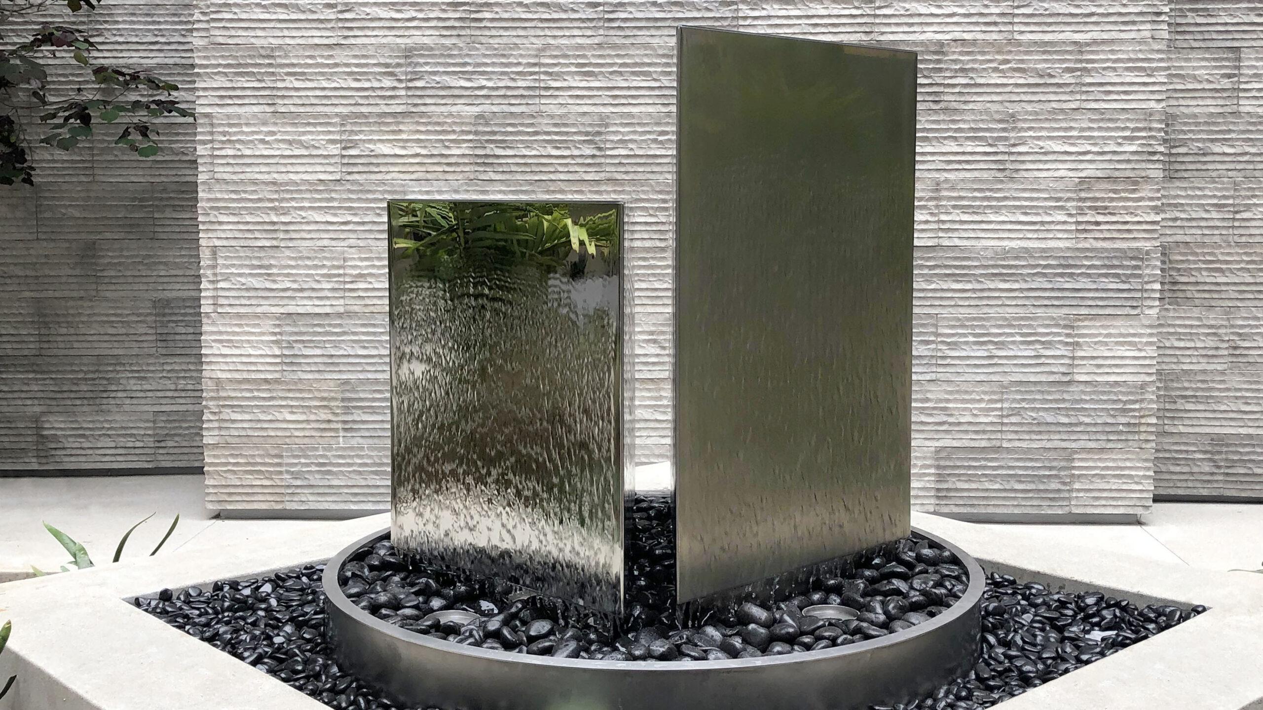 Install a sleek water feature to enhance tranquility in your modern backyard oasis