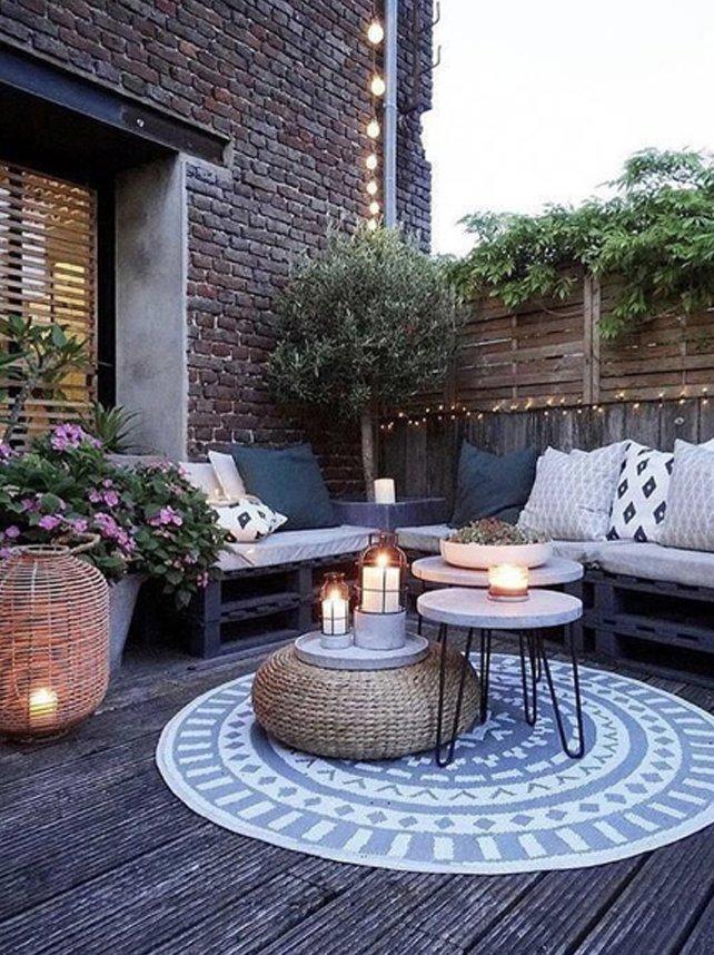 Integrate cozy blankets and pillows for comfort in outdoor seating arrangements