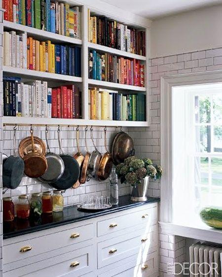 Designate a floating shelf for​ cookbooks and decorative items in your galley kitchen