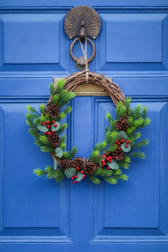 Festive wreath on navy blue door