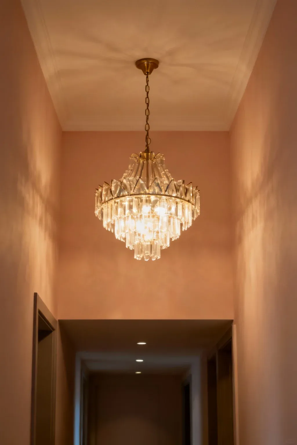 A striking chandelier illuminating a stylish hallway.