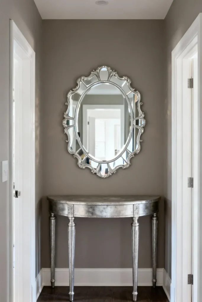 A decorative mirror enhancing the sense of space in a small entryway.