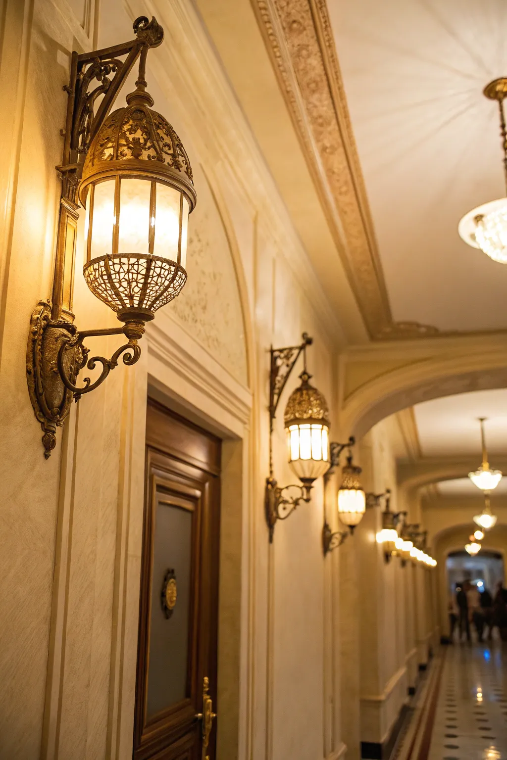 Elegant warm lighting fixtures illuminating a cream hallway.