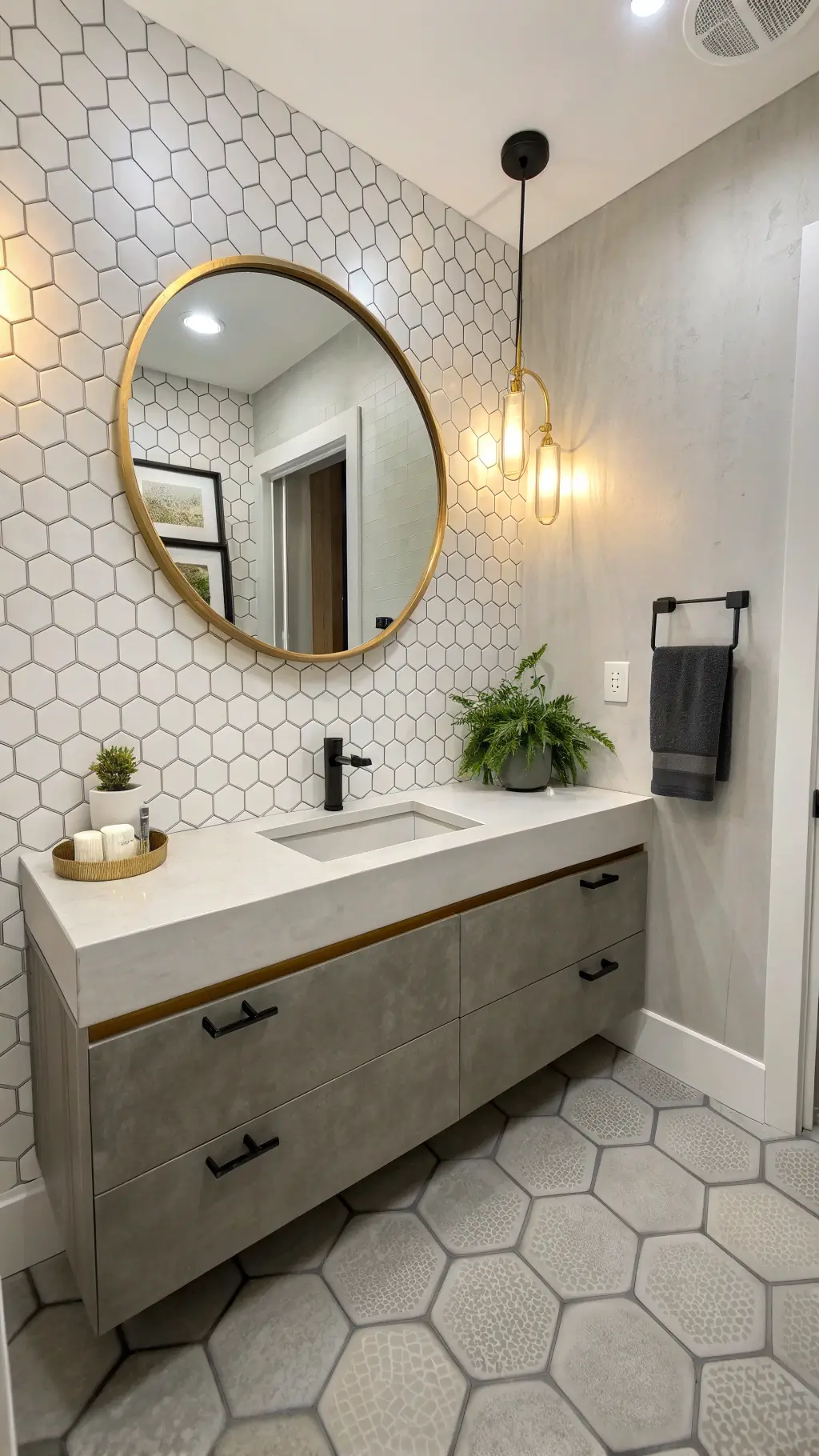 Chic urban powder room with concrete vanity, oversized round mirror, textured white tiles, geometric cement flooring, and warm ambient lighting during golden hour, accented by matte black sconces and natural elements like succulents and fiber towels