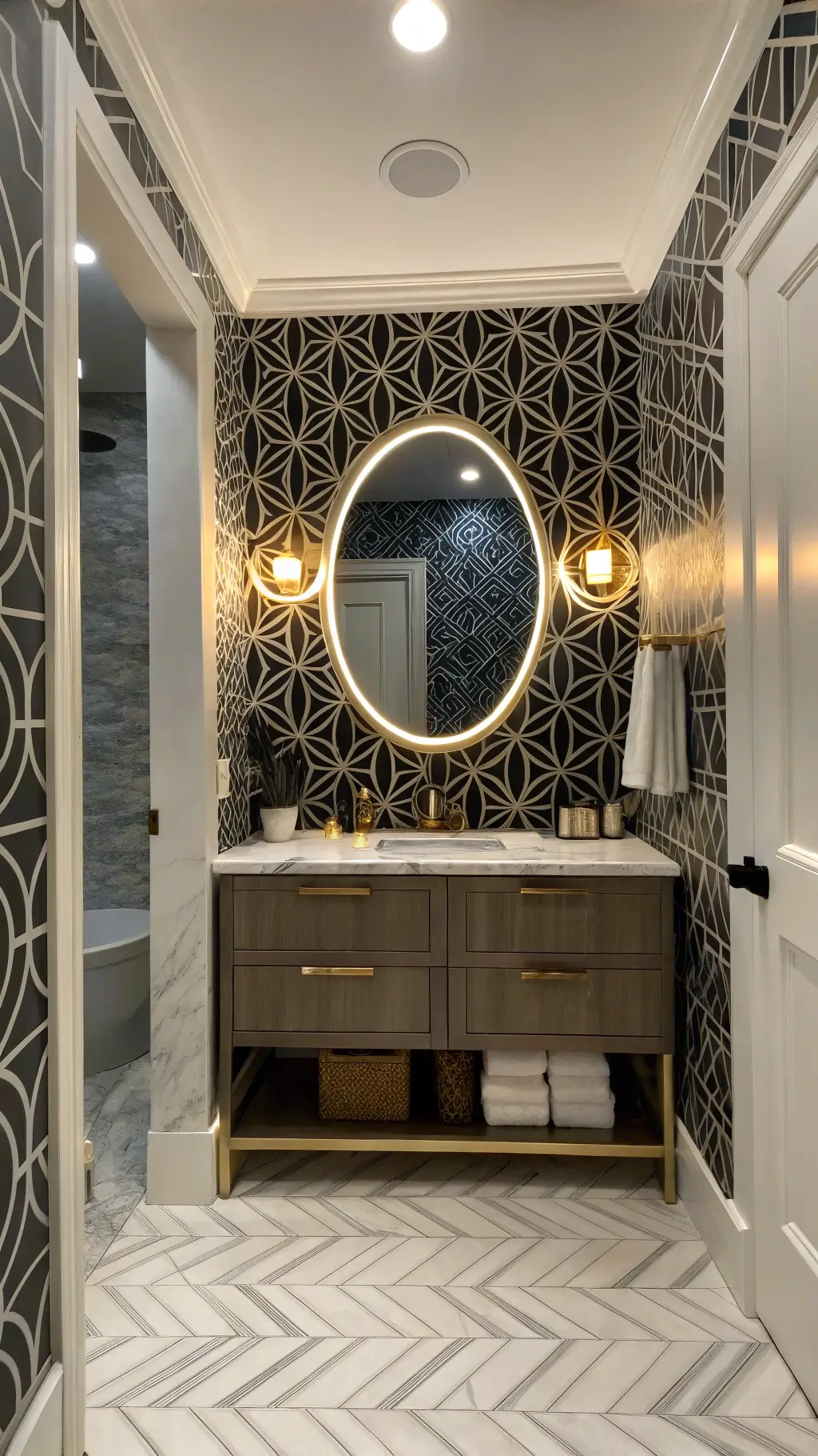 Elegant powder room with black and white geometric wallpaper, floating glass vanity with LED lighting, oversized round mirror with brass frame, herringbone marble floor tiles, and focused spotlights creating a chic ambiance