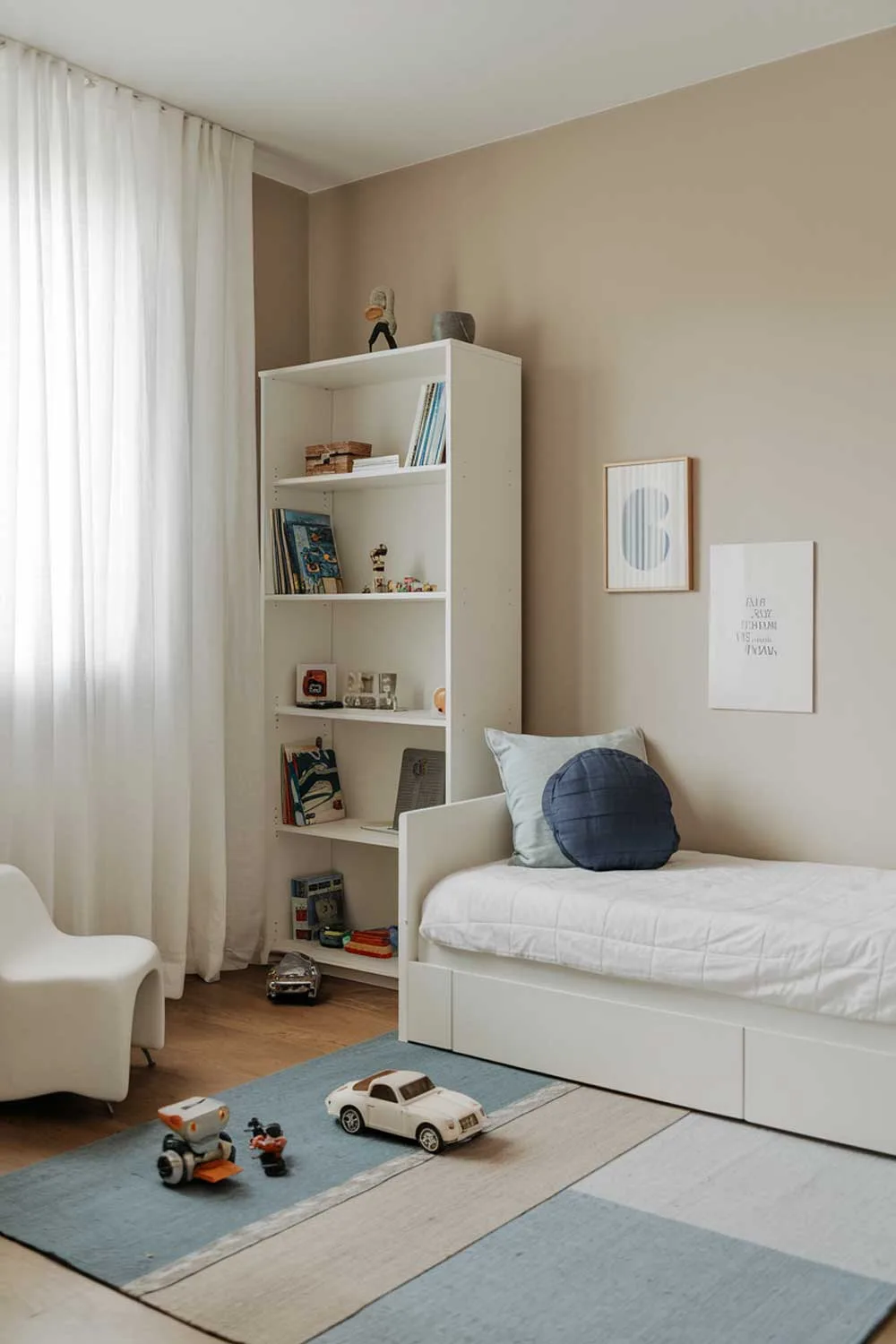 Minimalist boys bedroom with white furniture and blue accents