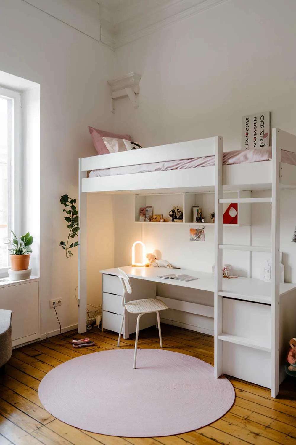 Minimalist girls bedroom with white loft bed and study area