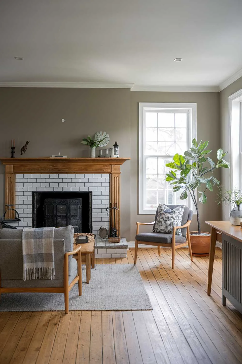 Scandinavian farmhouse living room with fireplace and muted gray walls