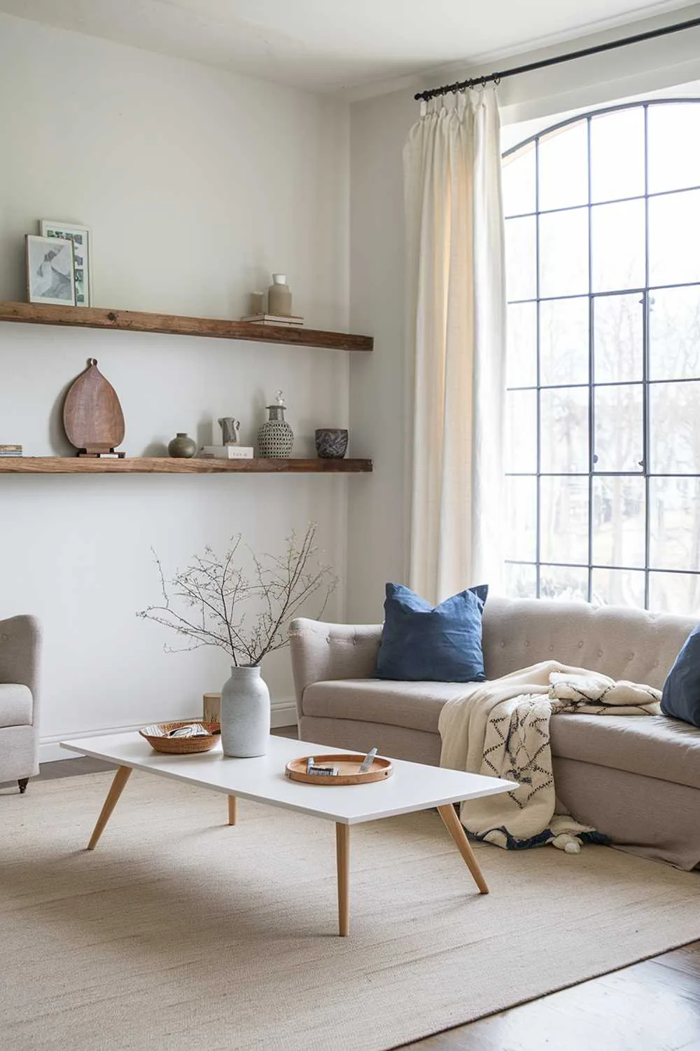 Simple Scandinavian farmhouse living room with blue cushions and white coffee table