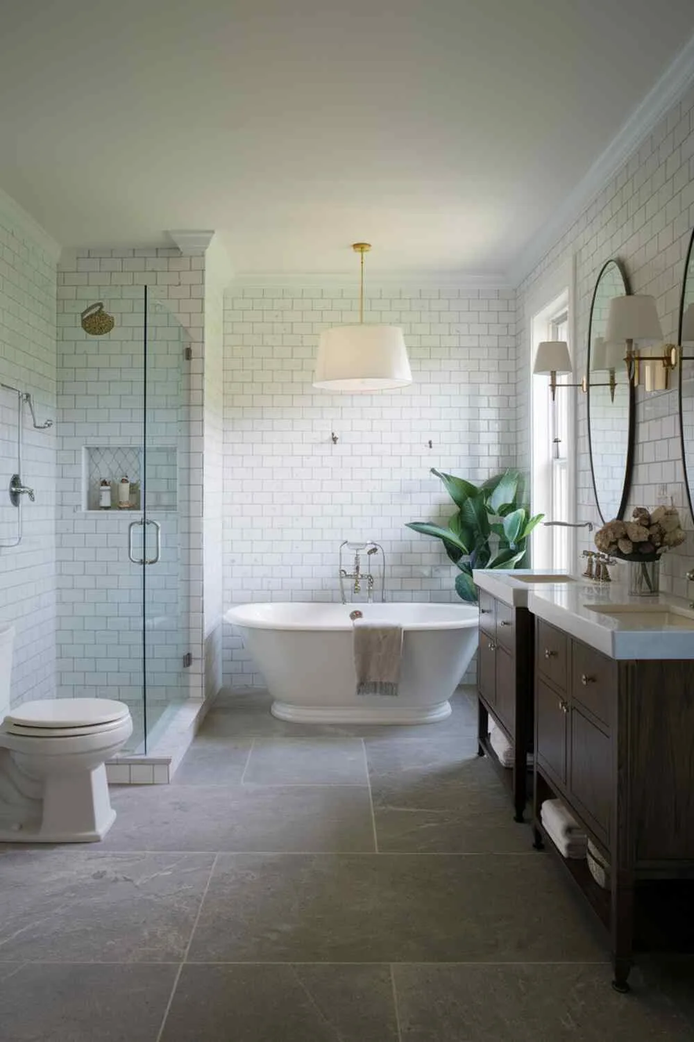 Modern bathroom with freestanding tub, separate shower, double vanity, and potted plant