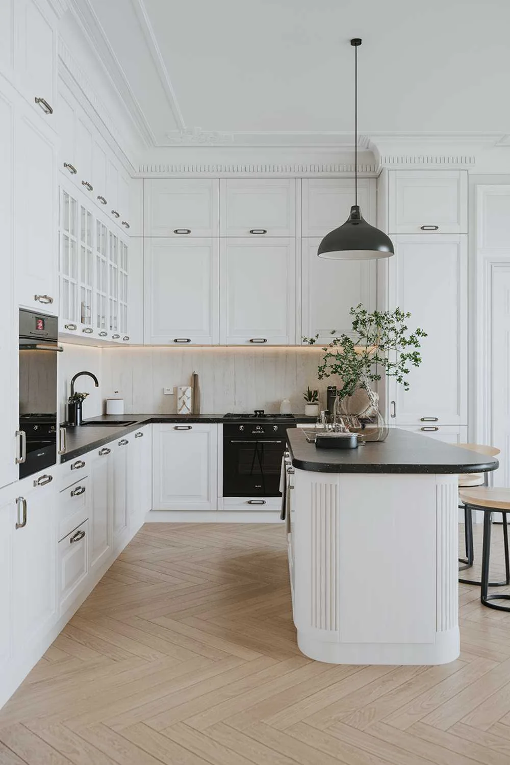 White kitchen island with black countertop and pendant lighting in Scandinavian kitchen