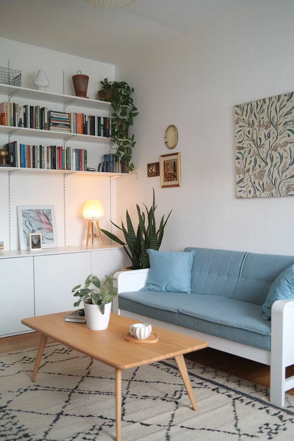 Scandinavian living room with white sofa and bookshelf