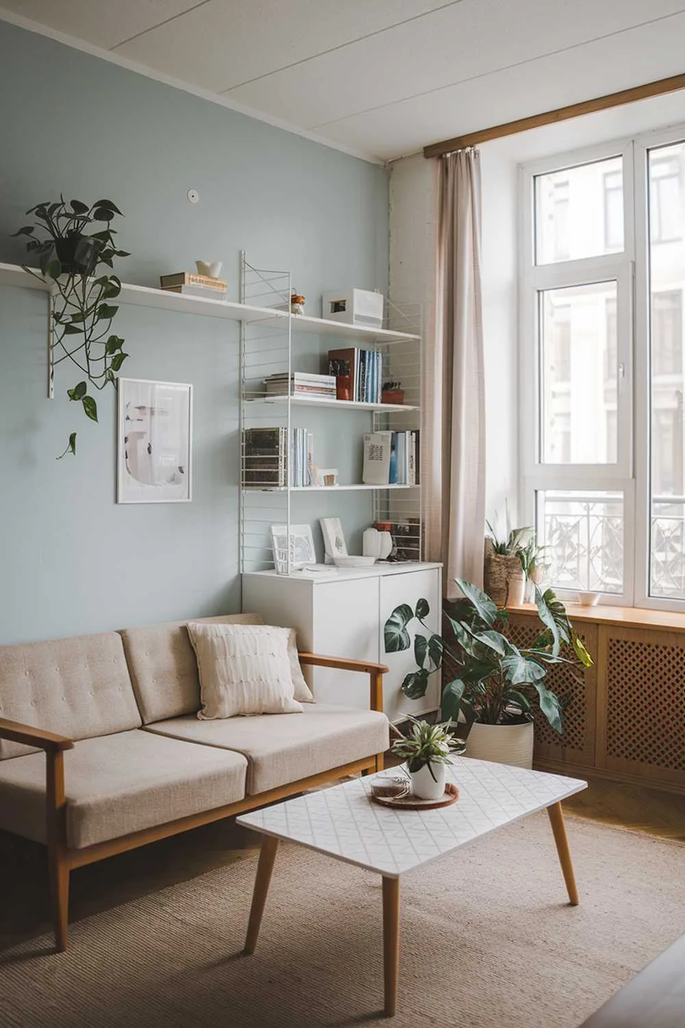 Scandinavian living room with light blue walls and wooden accents