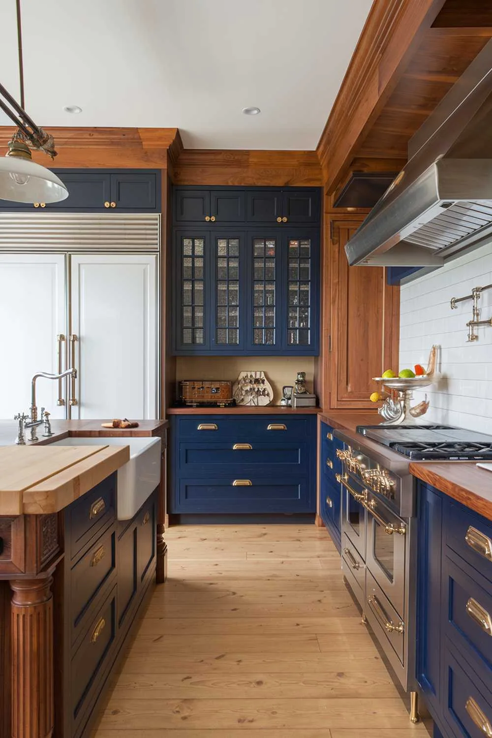 Blue and Brass Kitchen Kitchen with deep blue cabinets, butcher block island, and brass hardware