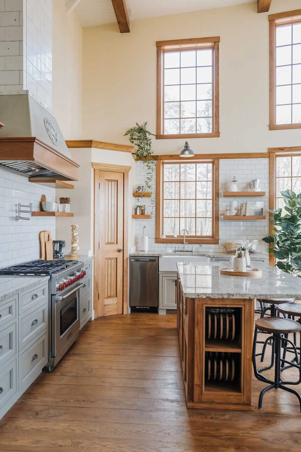 Grey and Wood Kitchen Balance Kitchen with light grey cabinets, granite island, and wooden floors