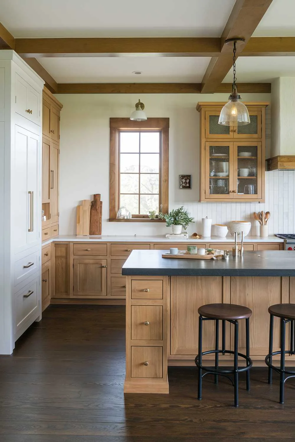 Mixed Materials Kitchen Kitchen with mixed cabinetry styles, dark wood floors, and pendant lighting