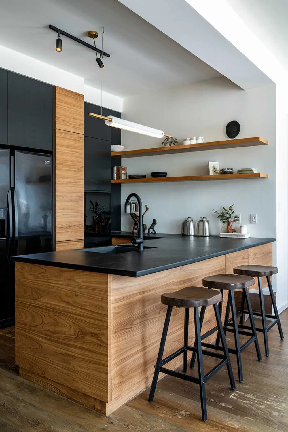 Large wooden island with black countertop, stools, black cabinetry, and wooden shelves