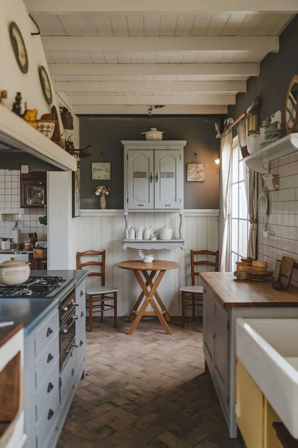 Kitchen corner with wooden table, gray cabinets, white shelves, vintage accessories, and tiled floor.