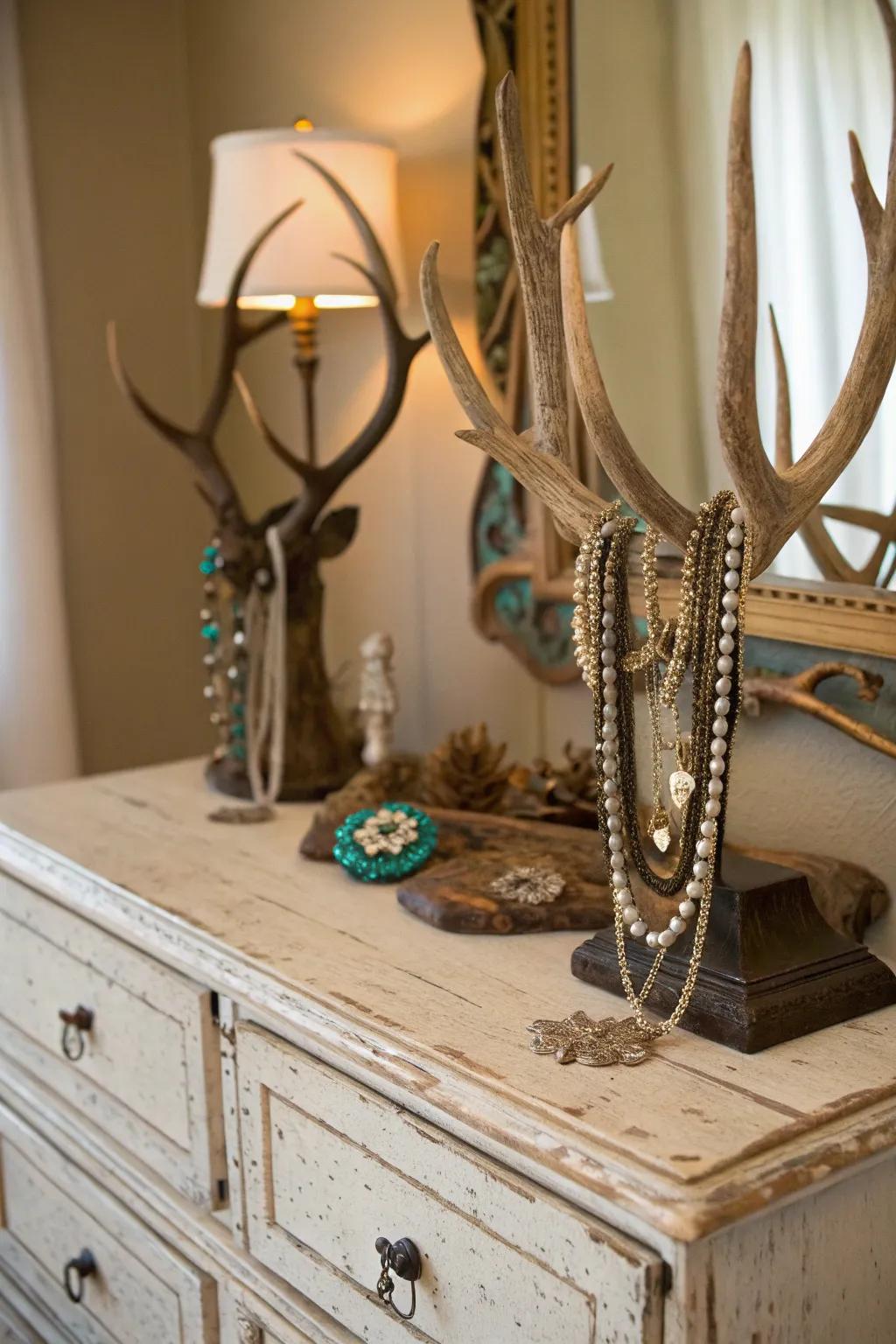 Deer antlers repurposed as a chic jewelry organizer on a vintage dresser.