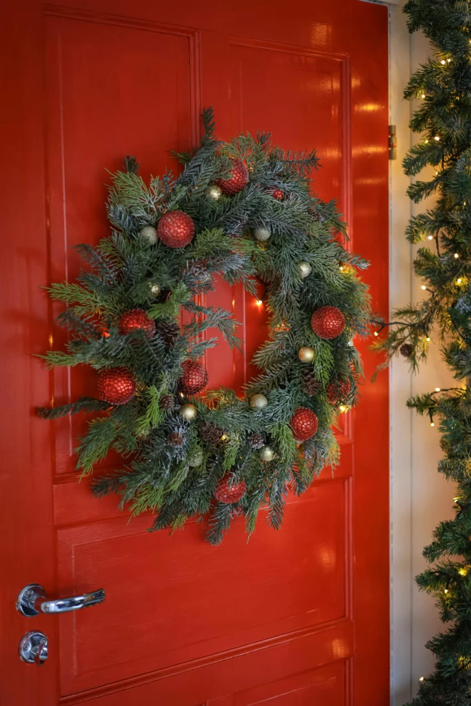 Classic red and green wreath on red door