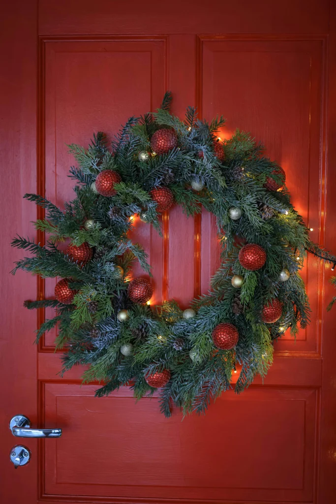 Lighted Green Wreath on Red Door