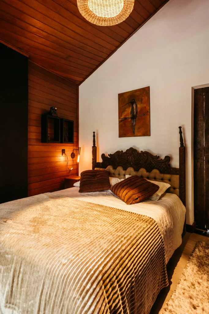 Rustic Bedroom with Wood Paneling and Wicker Light