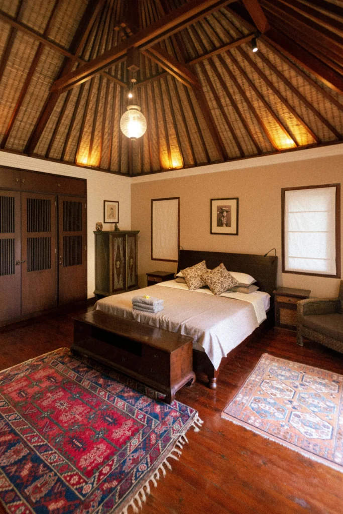 Globally Inspired Bedroom with Thatched Ceiling and Persian Rugs