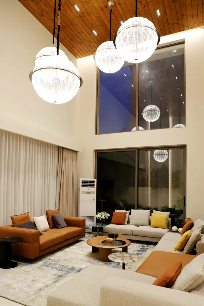 Modern Living Room with High Ceilings and Globe Pendant Lights
