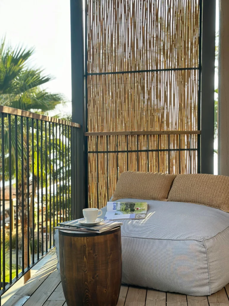 Light bean bag lounger with bamboo privacy screen and palm trees