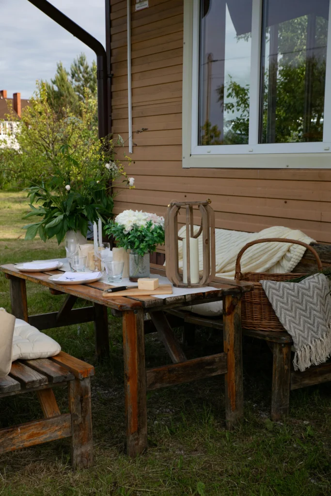 Weathered wooden picnic table with white florals and candles