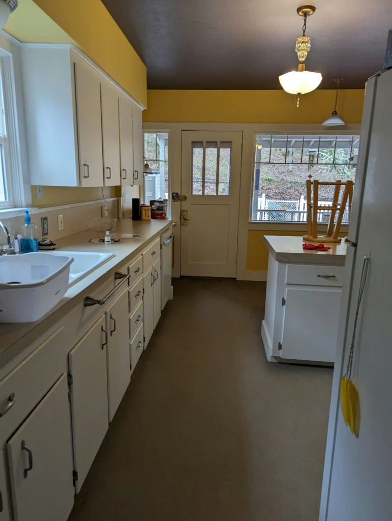 Kitchen with yellow walls and white cabinets