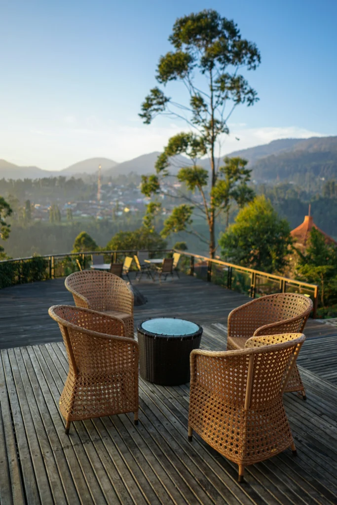 Outdoor deck with rattan chairs and mountain view