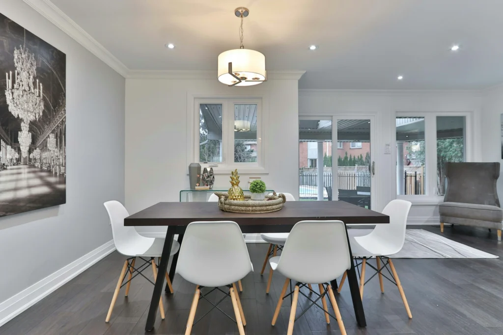 Dining room with dark wood table and white chairs