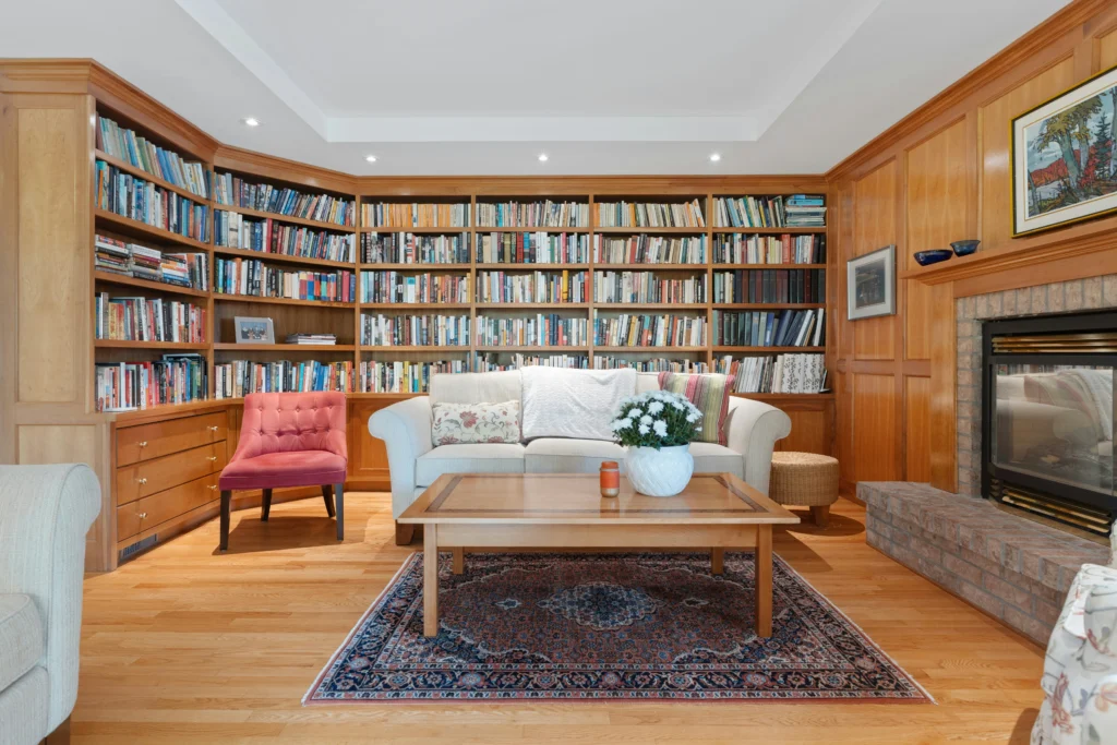 Cozy reading room with built-in bookshelves and fireplace