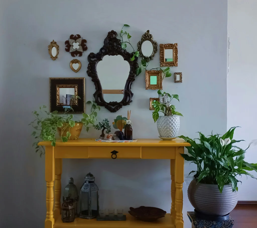 Living room with bright yellow console and eclectic gallery wall