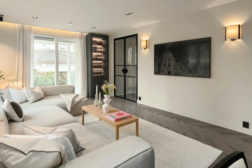 Living room with dark herringbone floor and light sectional