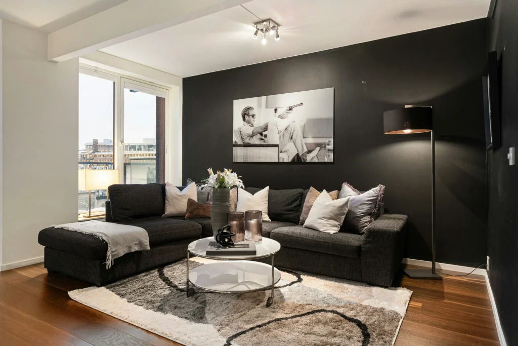 Living room with dark accent wall and gray sectional