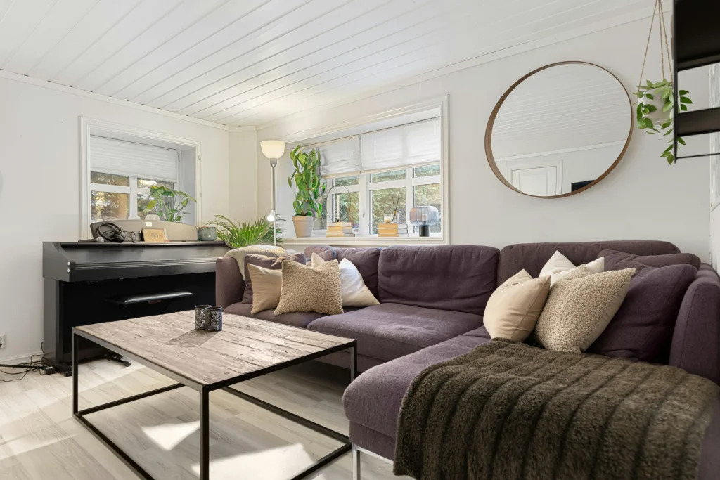 Cozy living room with purple sectional and rustic coffee table