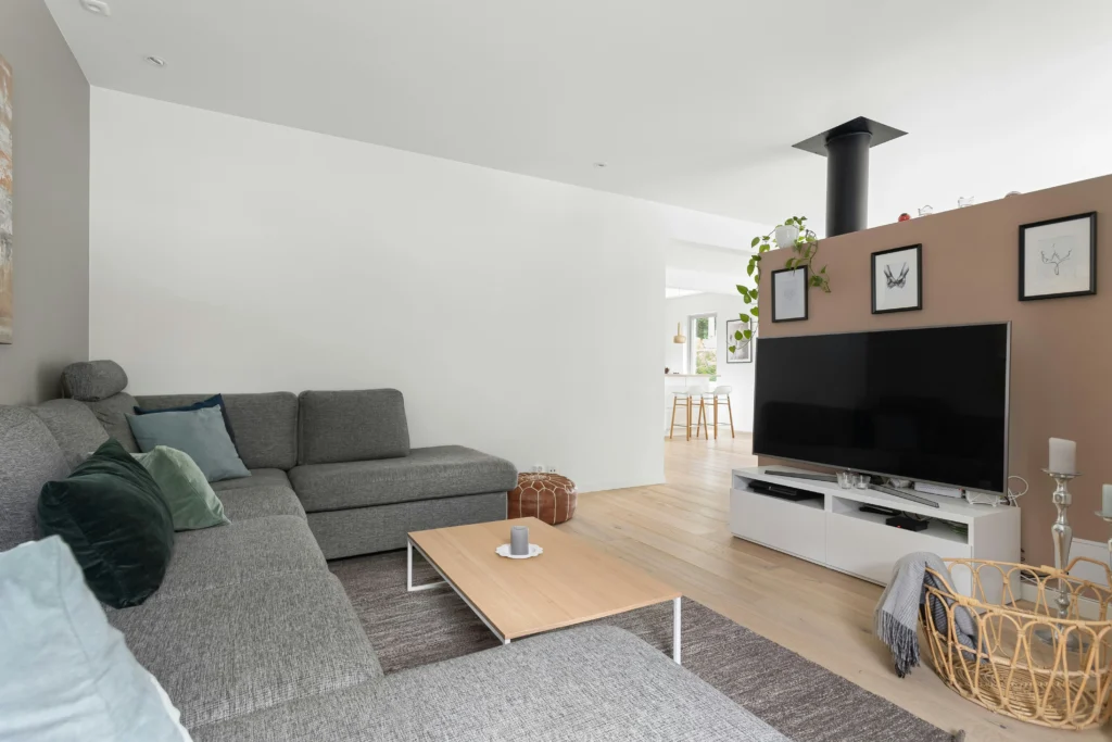 Open floor plan living and dining area with gray sectional