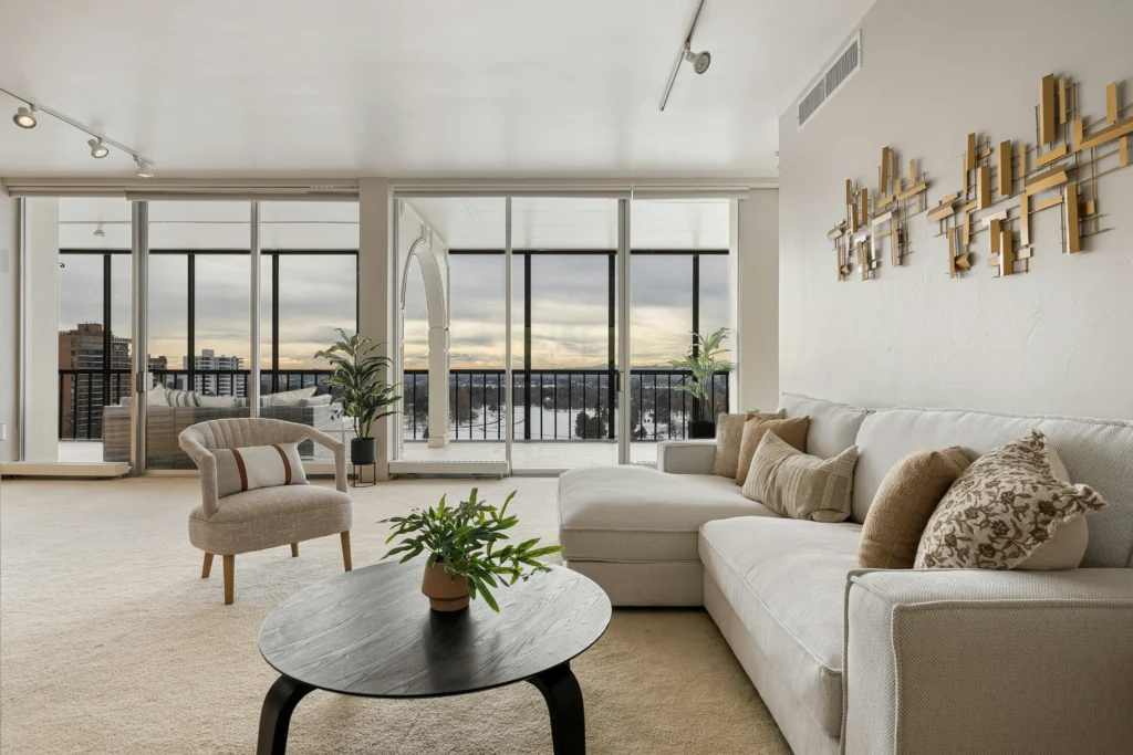 Living room with floor-to-ceiling windows and neutral furniture