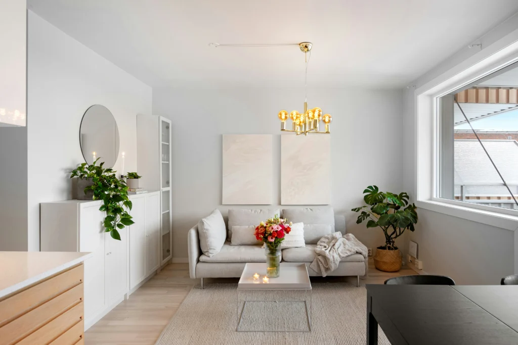 Bright living room with white walls and brass chandelier