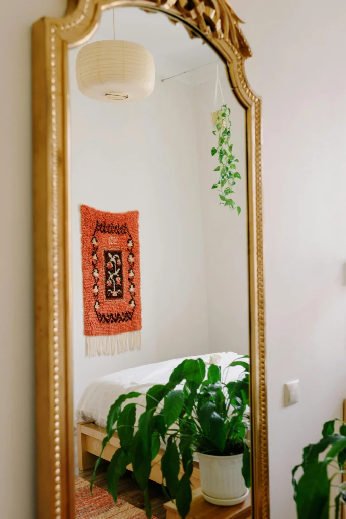 Large mirror reflecting natural light in bedroom